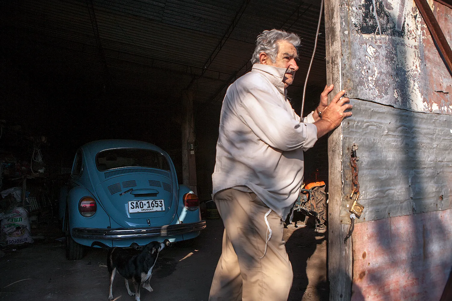 José Mujica opens his garage housing his Volkswagen Beetle.