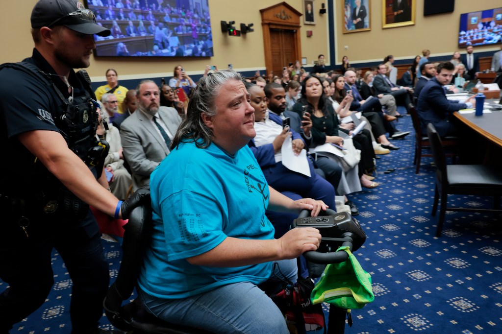 The committee room was surrounded by activists fearing cuts or increased costs to Medicaid.