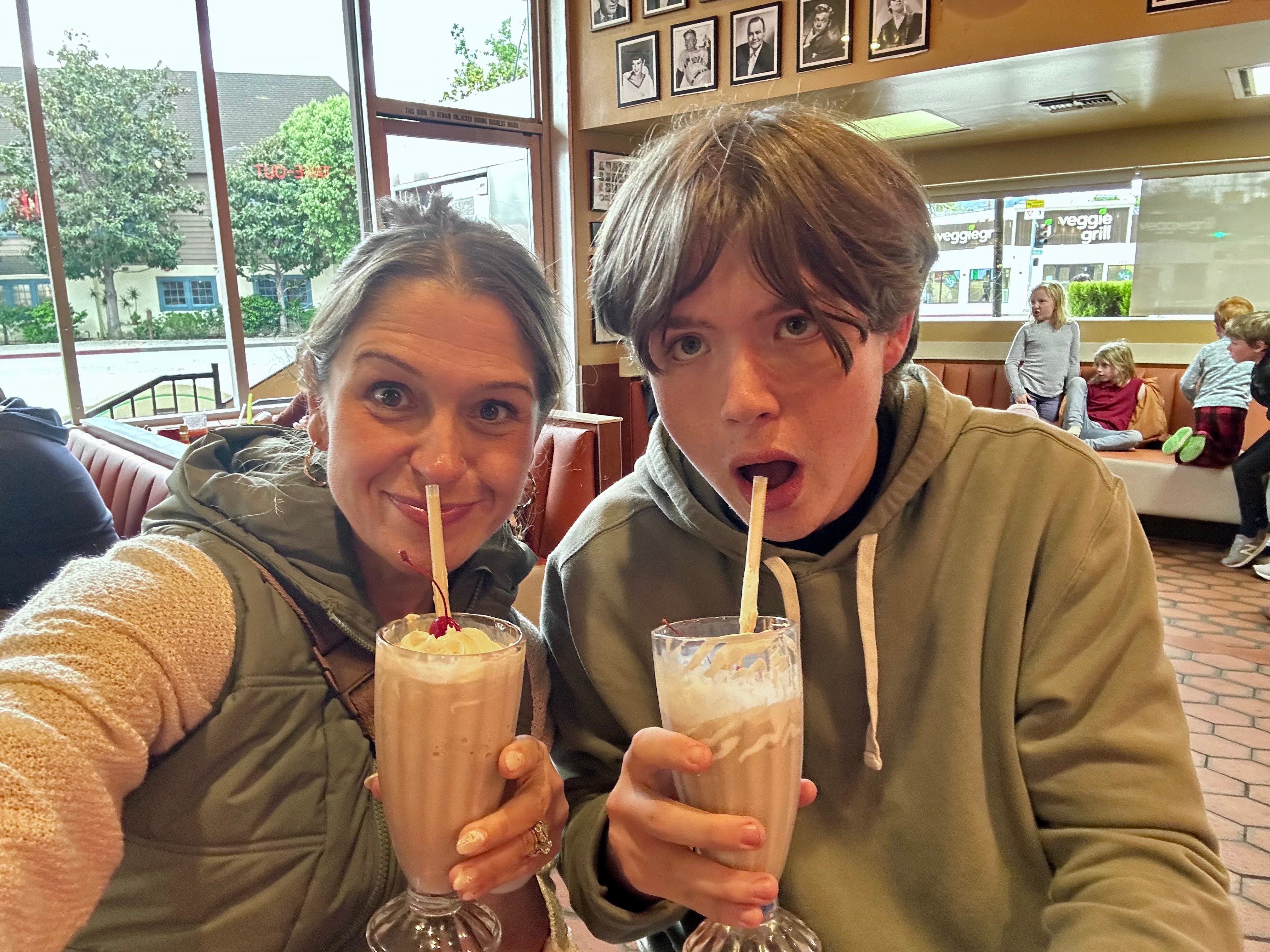 The author and her son drinking chocolate milkshakes.