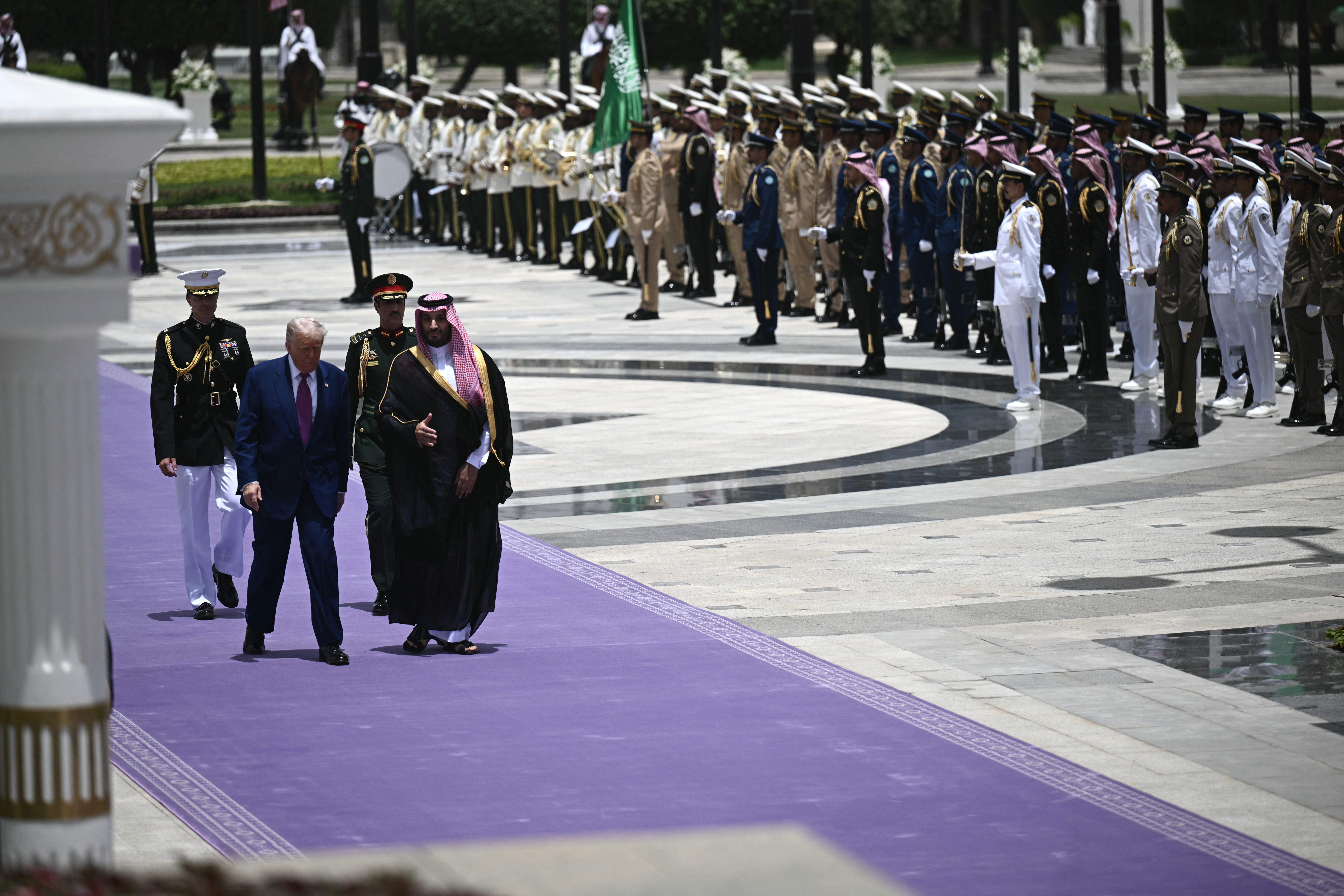 image of Trump and crown prince walking on purple carpet