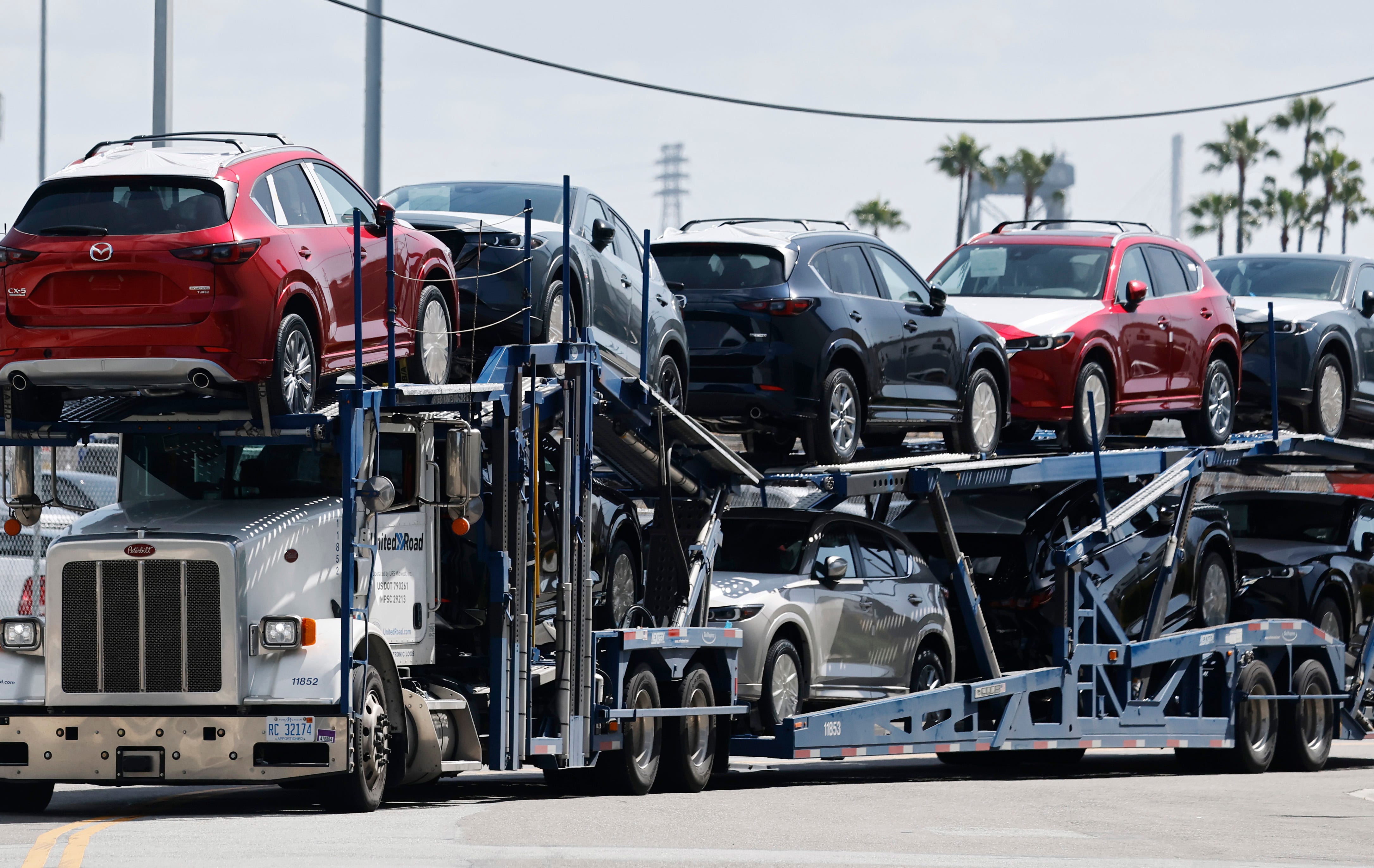 New Mazda cars are driven away from an automobile processing terminal on a car hauler at the Port of Los Angeles on April 3, 2025