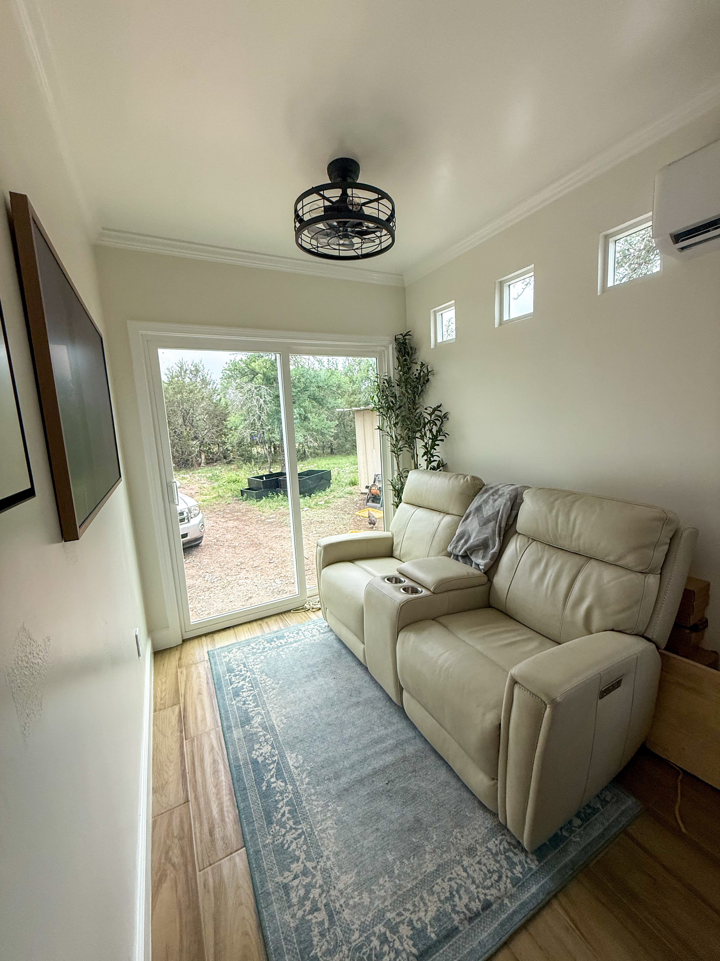 A living area with a couch and glass doors.