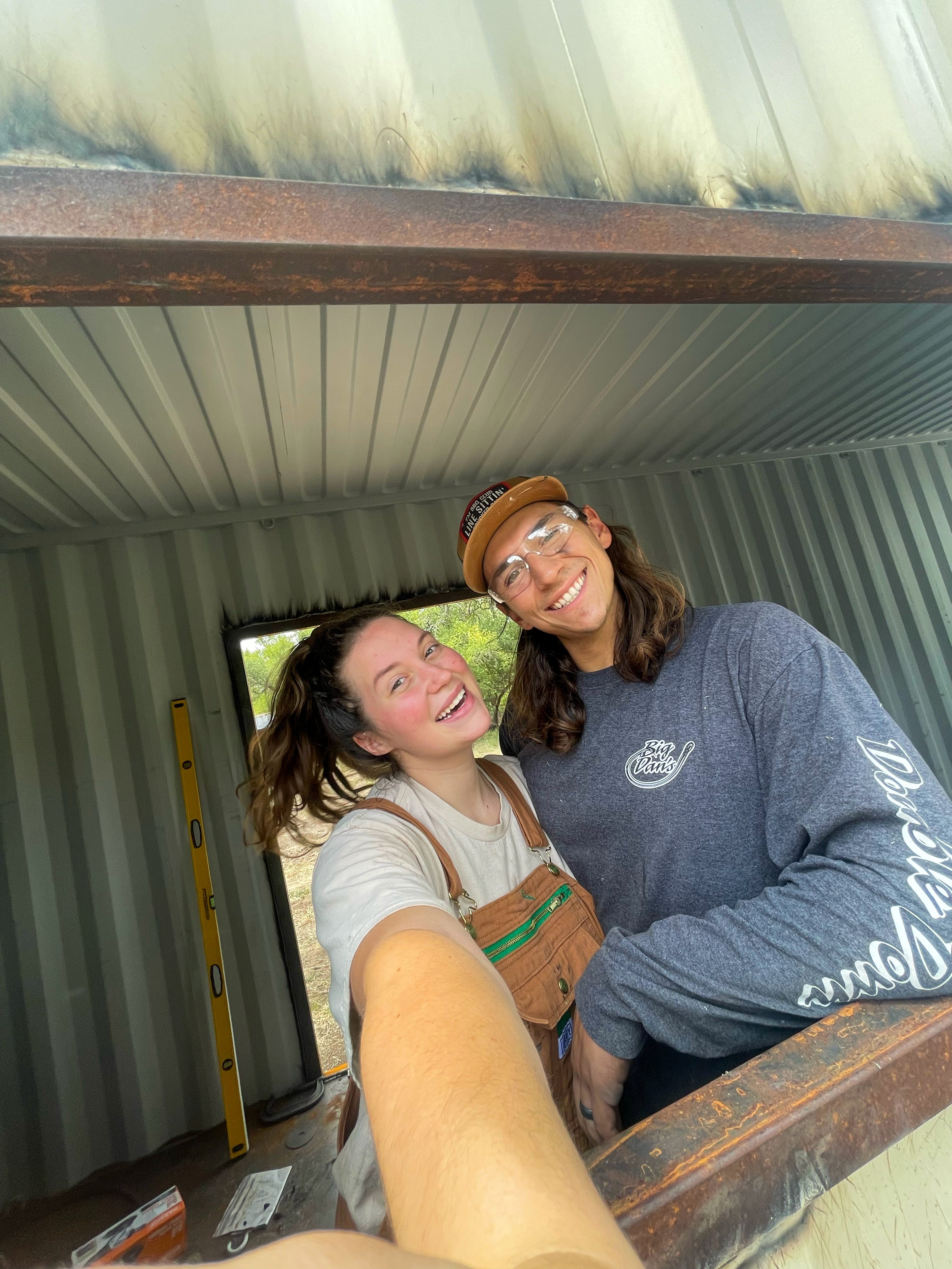 A selfie of a couple inside a construction site.