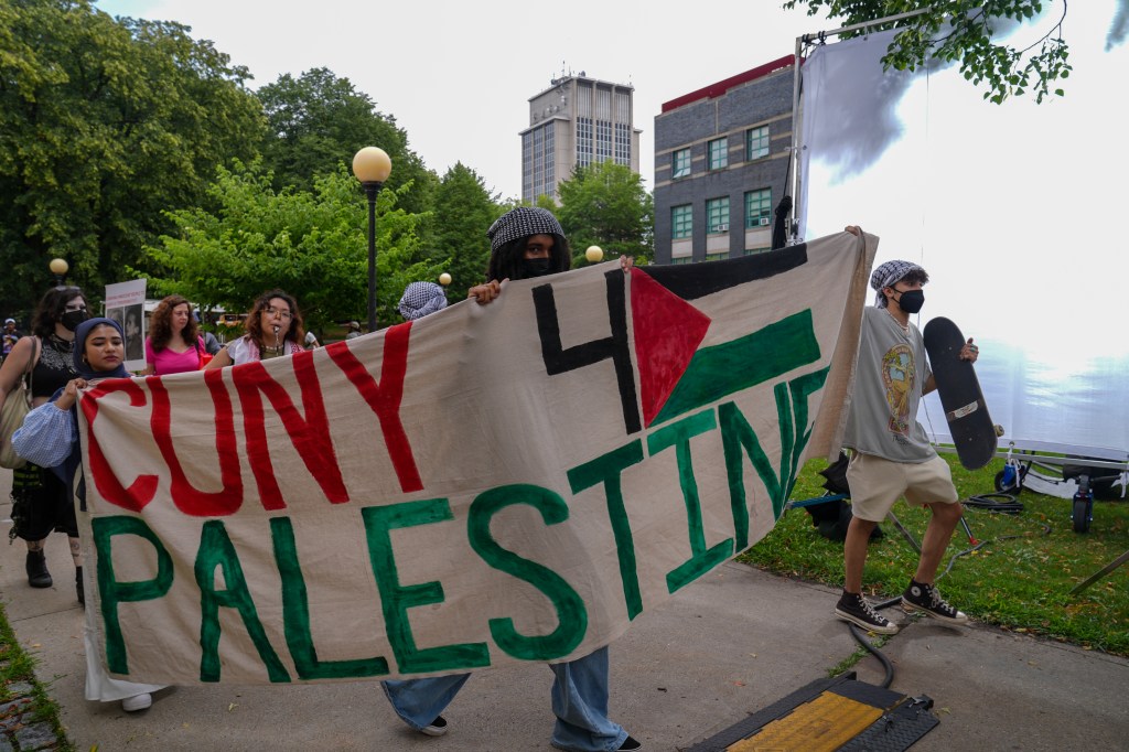 Pro-Palestinian students protesting against the filming of 'FBI: Most Wanted' at Queens College, City University of New York, featuring a chase, arrest, and explosion scene.
