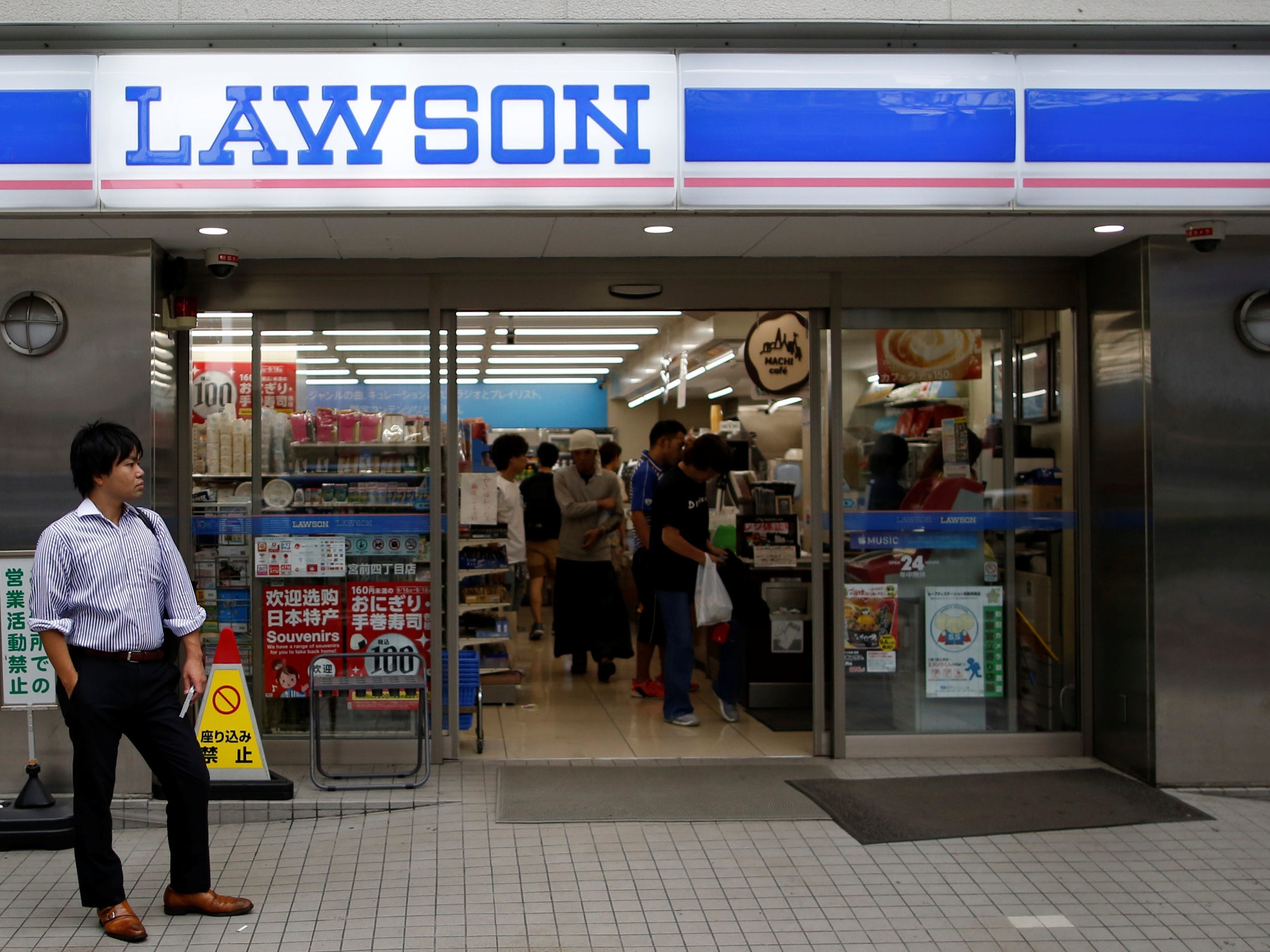 A man stands in front of a Lawson store