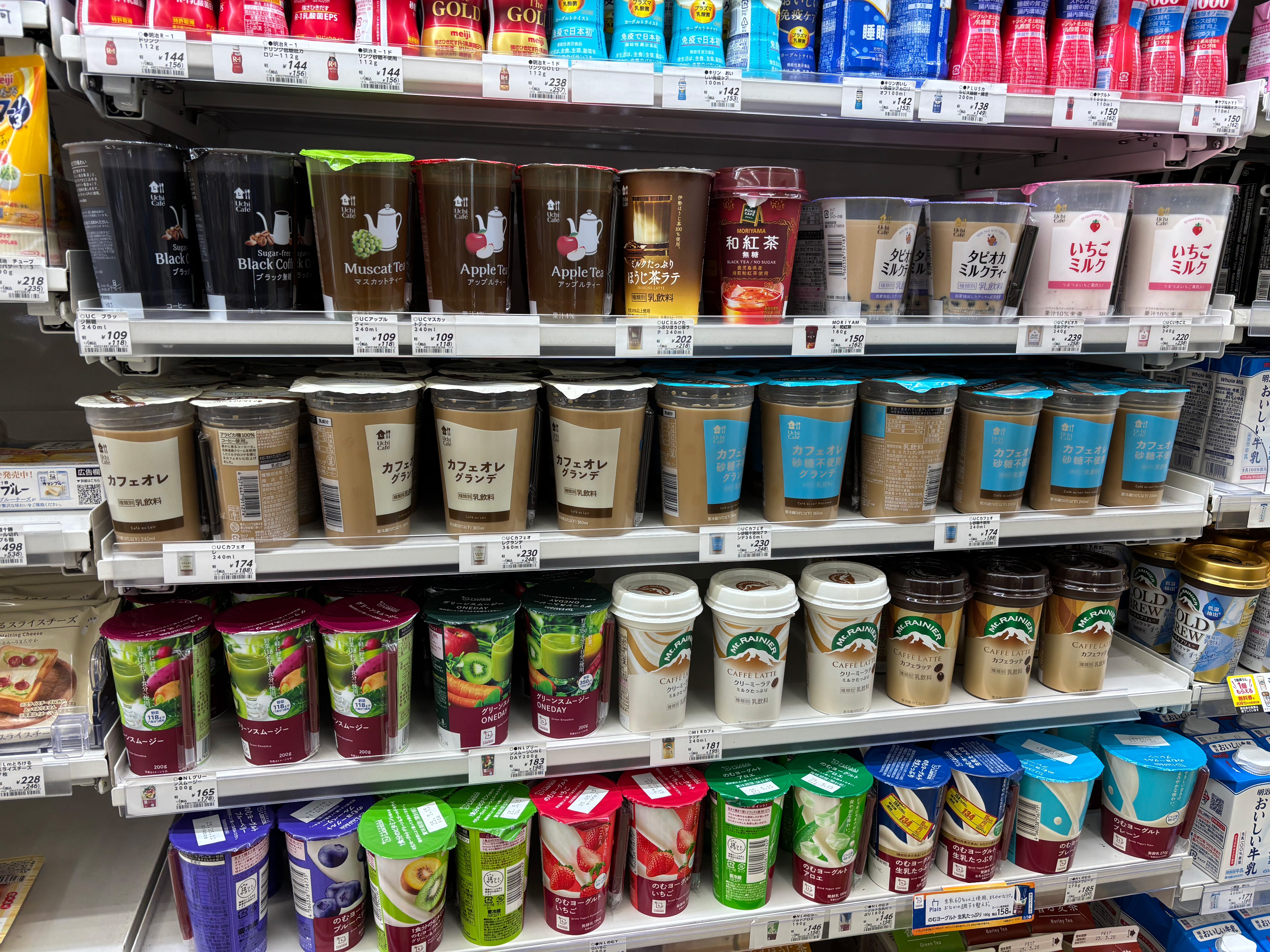 Shelves filled with to-go cups of coffee and other beverages with Japanese writing on them