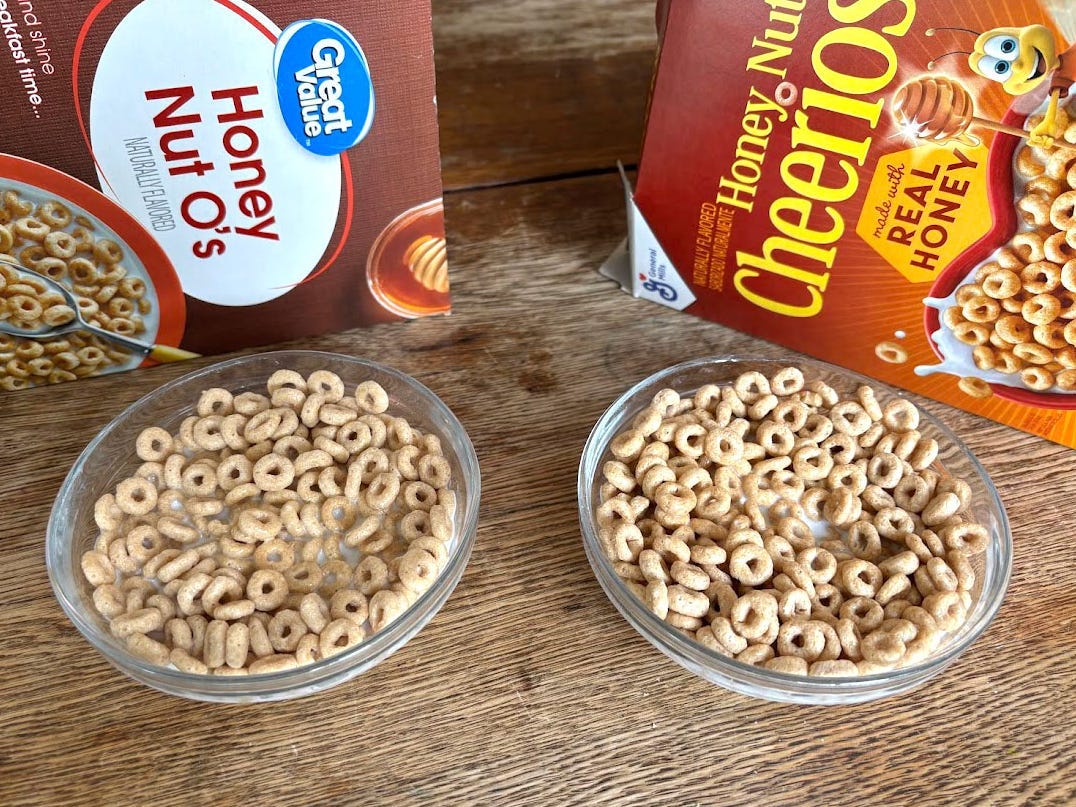 Boxes of Walmart Great Value Honey Nut O's and General Mills Honey Nut Cheerios, with bowls of each cereal in milk.