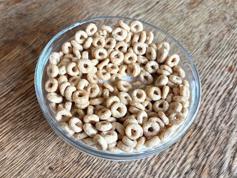 A bowl of Honey Nut Cheerios with milk.