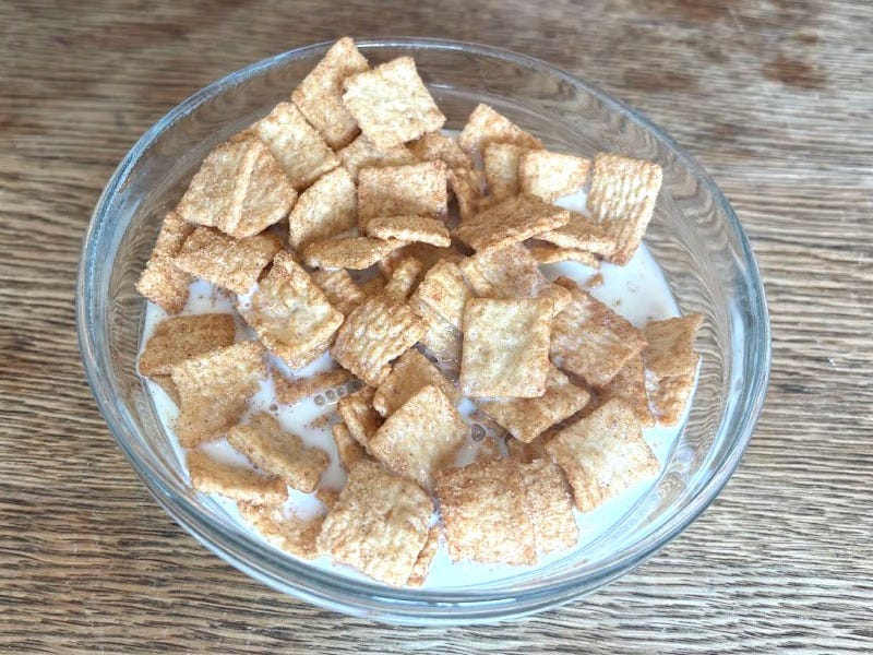 A bowl of Great Value Cinnamon Crunch cereal with milk.