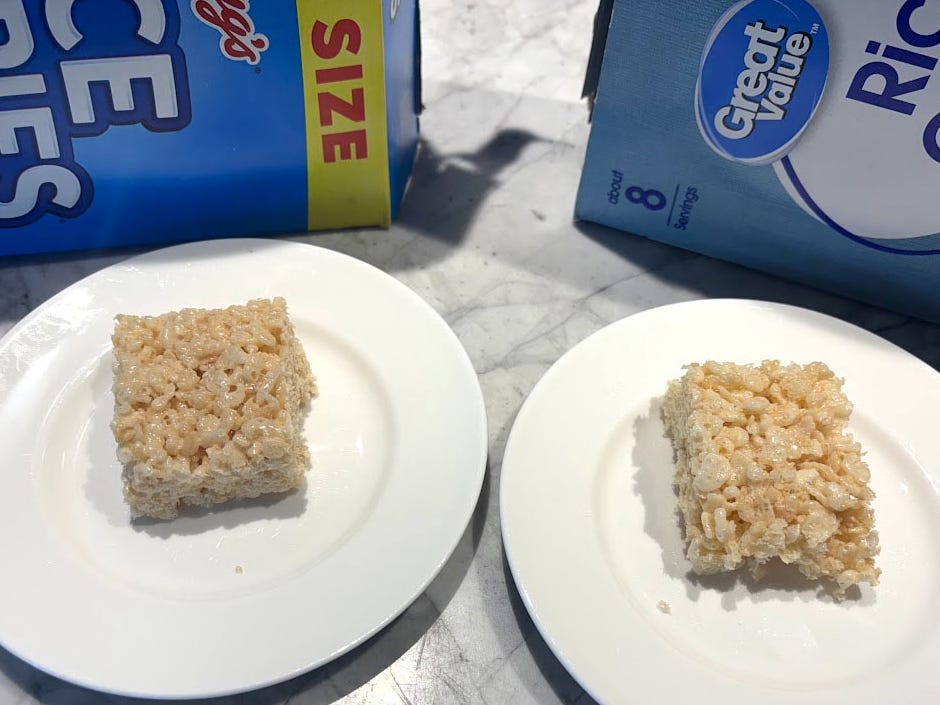 Two Rice Krispy treats on white plates, with Kellogg's and Great Value cereal boxes in the background.