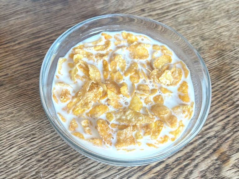 A bowl of Great Value Frosted Flakes with milk.