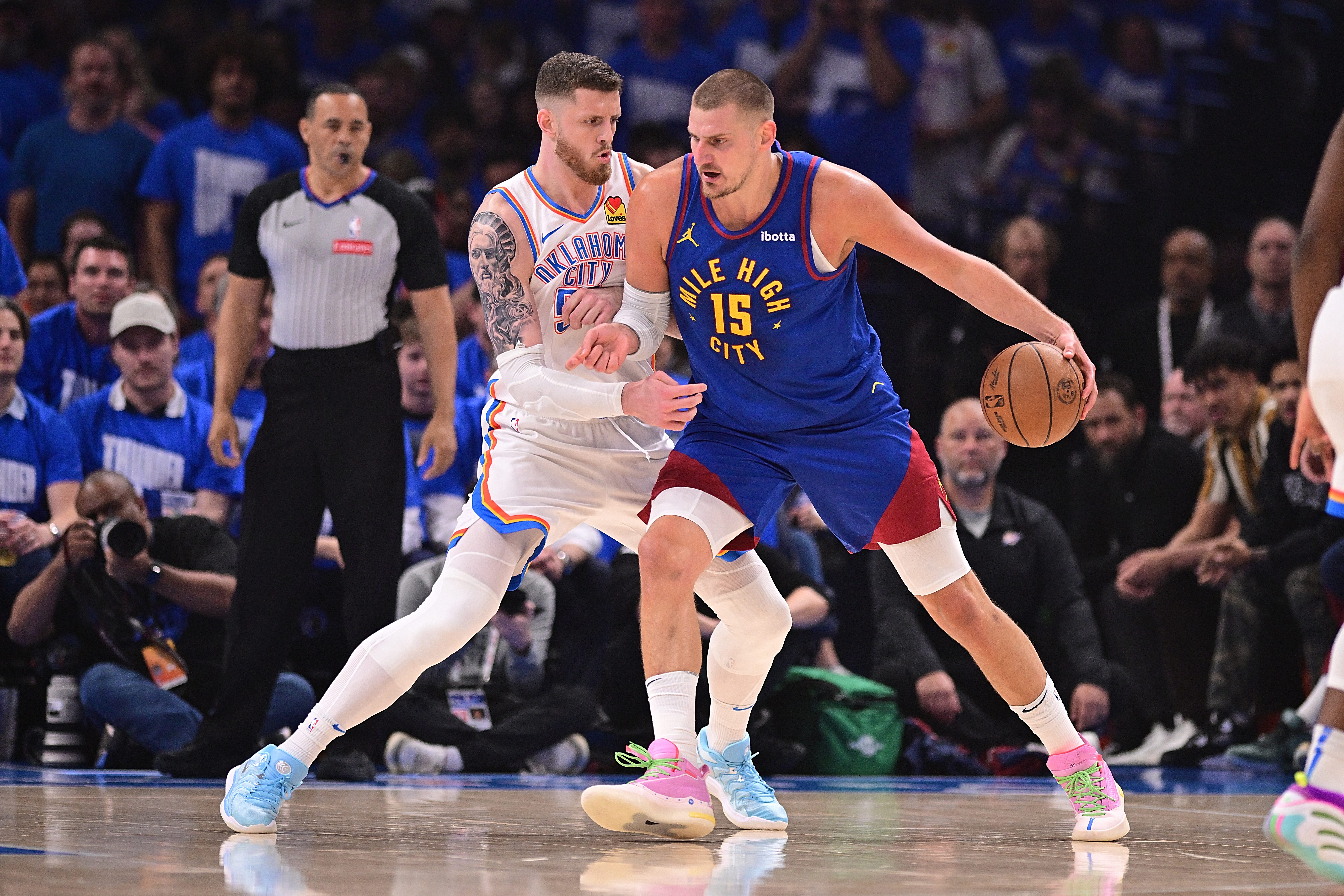 Nikola Jokic drives to the net in a playoff game between the Denver Nuggets and the Oklahoma City Thunder