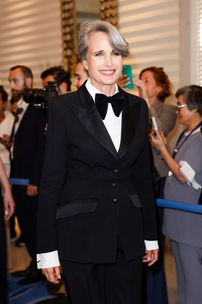 Andie MacDowell smiling in a suit at the Cannes Film Festival 2025
