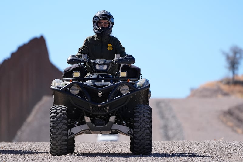 US Secretary of Homeland Security Kristi Noem rides a four-wheeler during a tour along the Nogales border wall at the Mariposa Port of Entry in Nogales, Arizona, March 15, 2025.