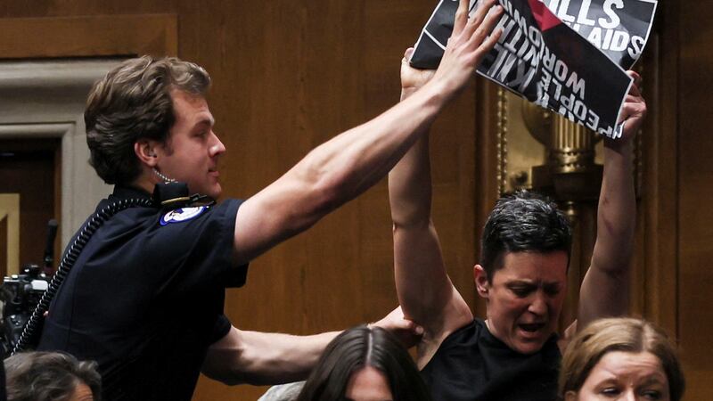 A protester is removed by U.S. Capitol Police as U.S. Health and Human Services (HHS) Secretary Robert F. Kennedy Jr. (Not Pictured) testifies before a Senate Health, Education, Labor & Pensions Committee hearing on the Department of Health and Human Services budget, on Capitol Hill in Washington, D.C., U.S., May 14, 2025. REUTERS/Leah Millis