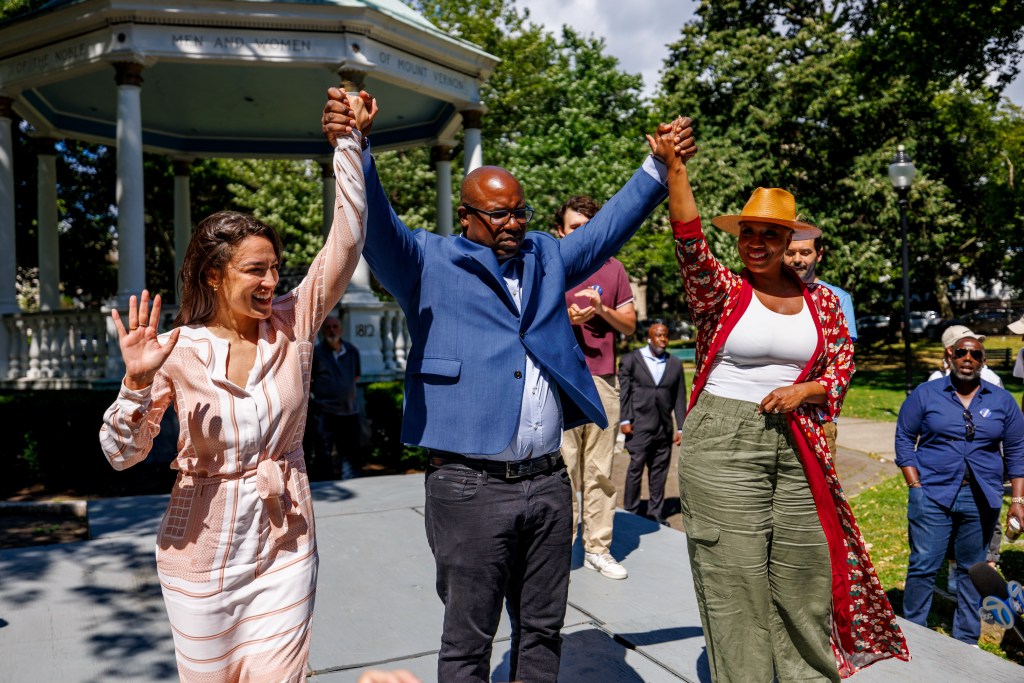 Rep. Jamaal Bowman raising the hands of fellow squad members Rep. Alexandria Ocasio-Cortez and Rep. Ayanna Presley at a get-out-the-vote rally in Mount Vernon, New York on June 24, 2024.