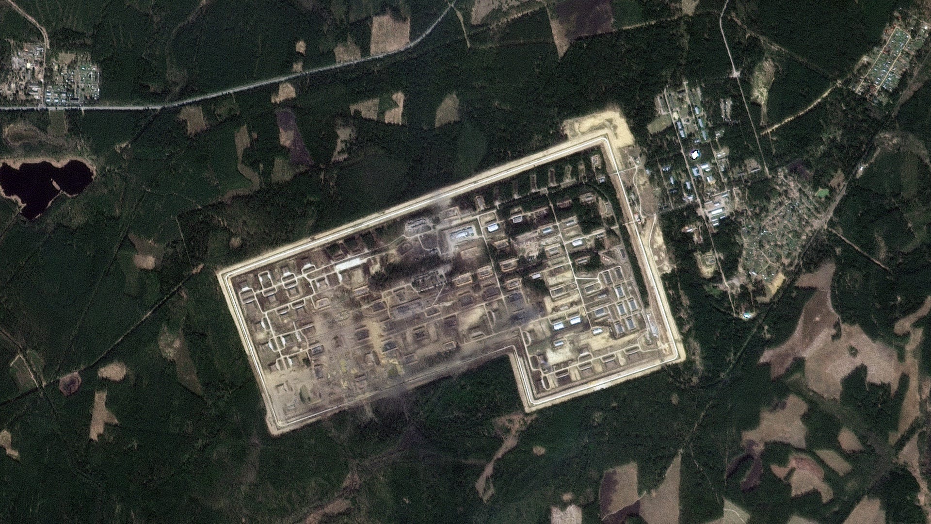 A satellite image shows a damaged ammo depot.