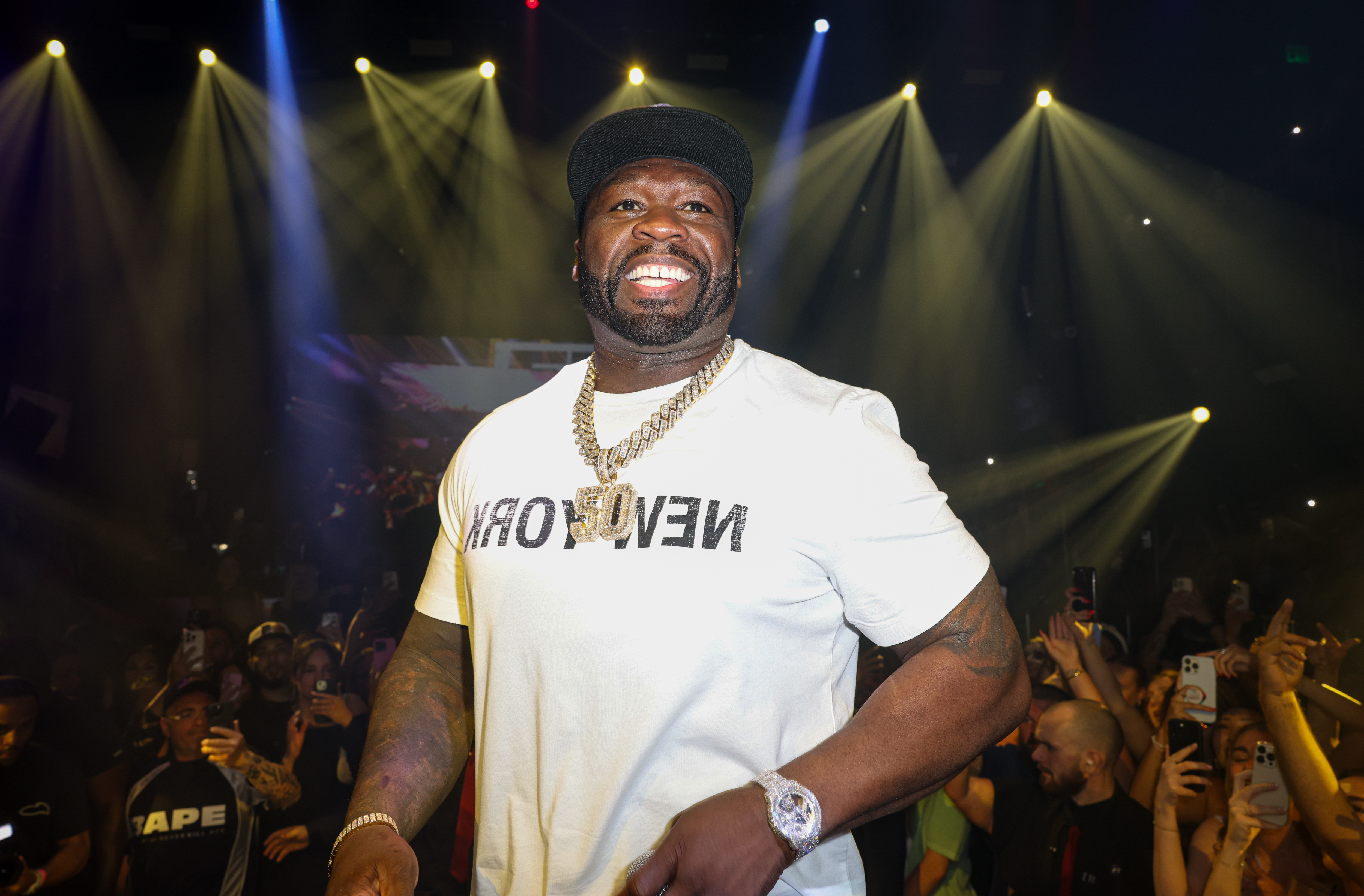 50 Cent onstage smiling. 