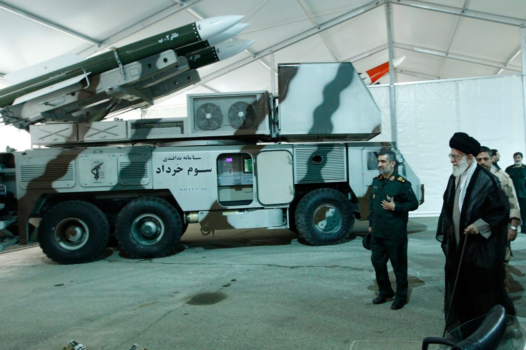 In this photo released on May 11, 2014, by an official website of the office of the Iranian supreme leader, Third of Khordad air defense system is displayed while Supreme Leader Ayatollah Ali Khamenei, right, visits