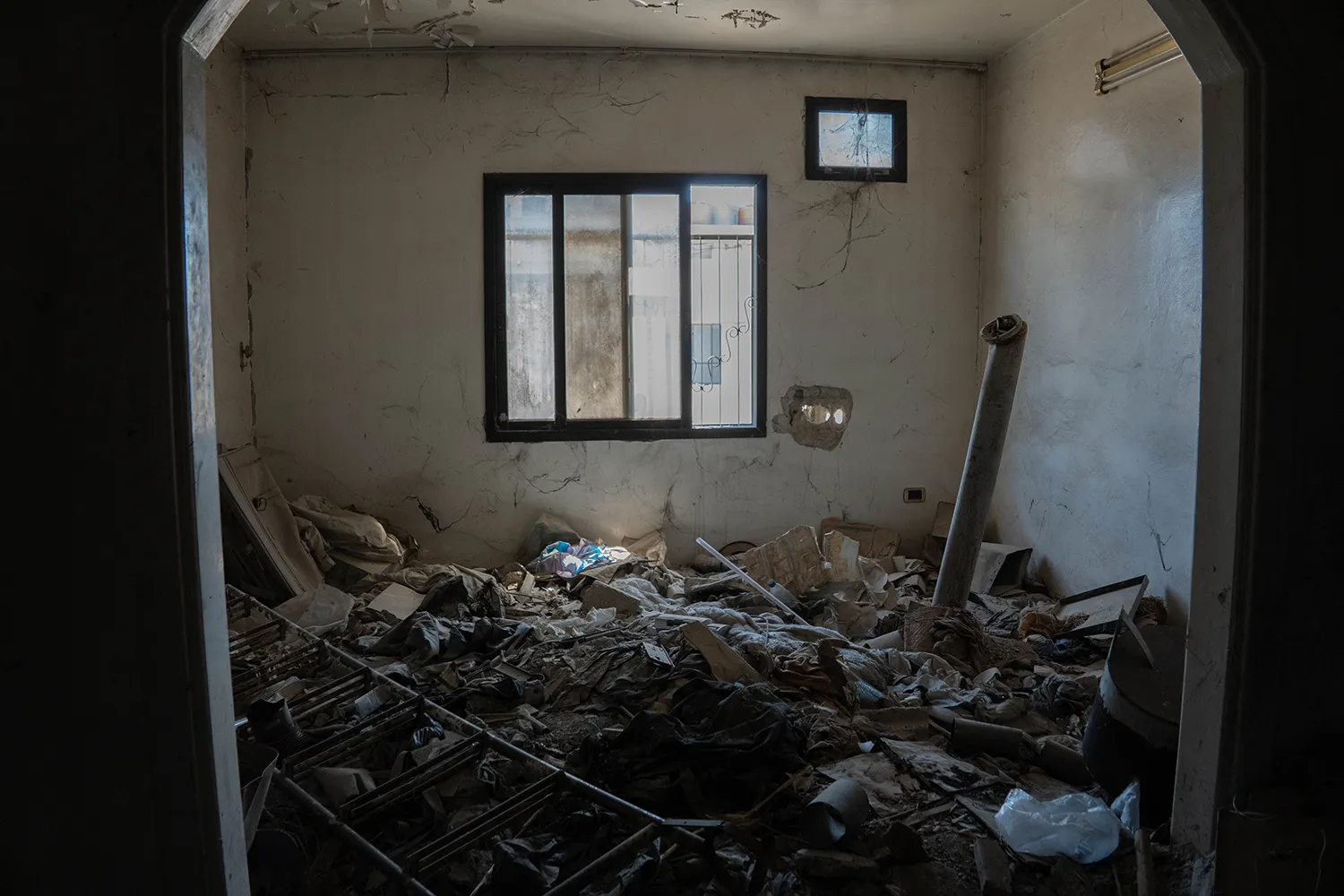 A rocket rests amid debris in a building in Zamalka.