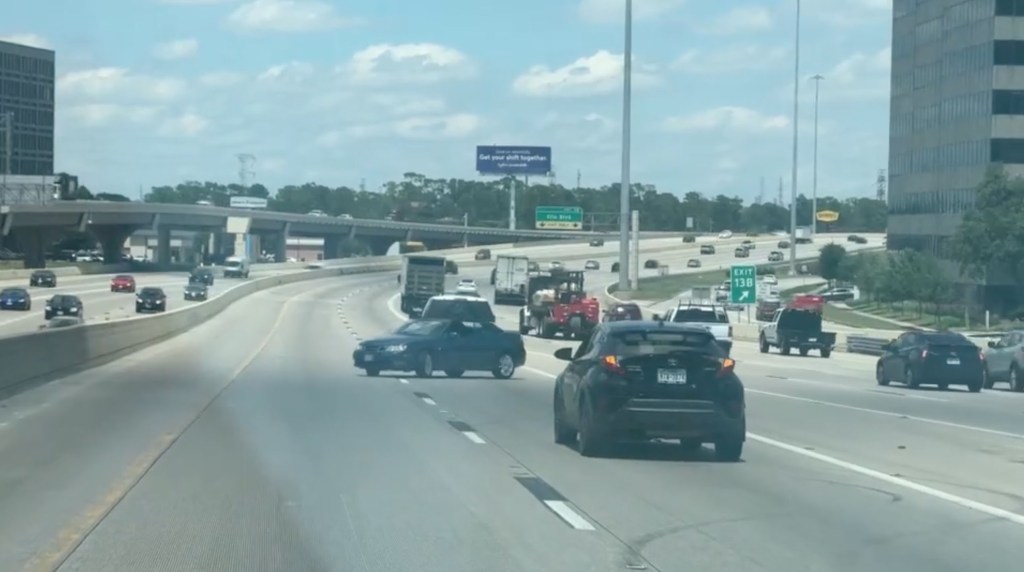 The blue sedan was being towed backwards along Houston's North Loop.