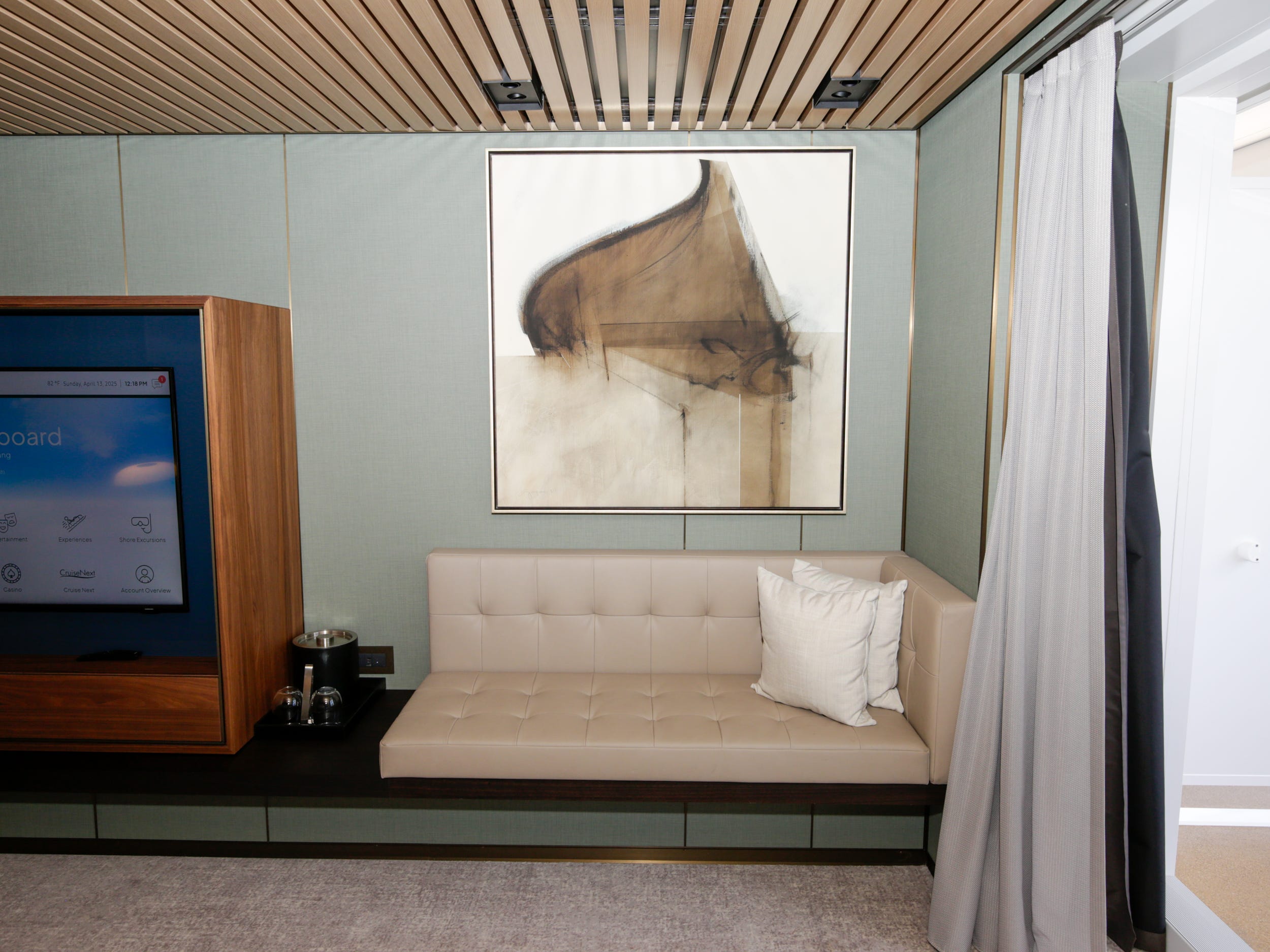 empty couch under a wall decor in the Haven Penthouse with Balcony on Norwegian Aqua