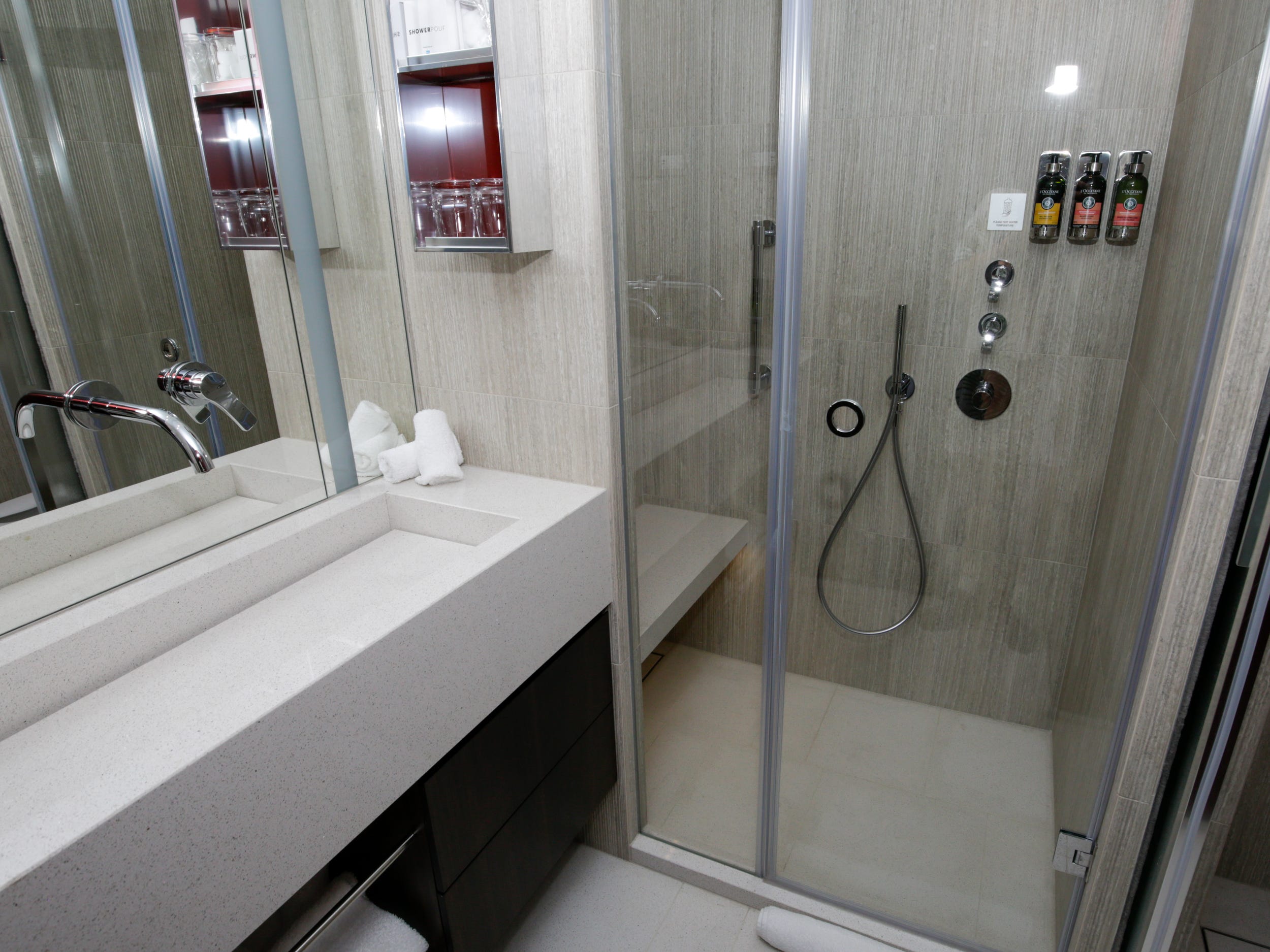 empty bathroom with a shower, sink in the Haven Penthouse with Balcony on Norwegian Aqua