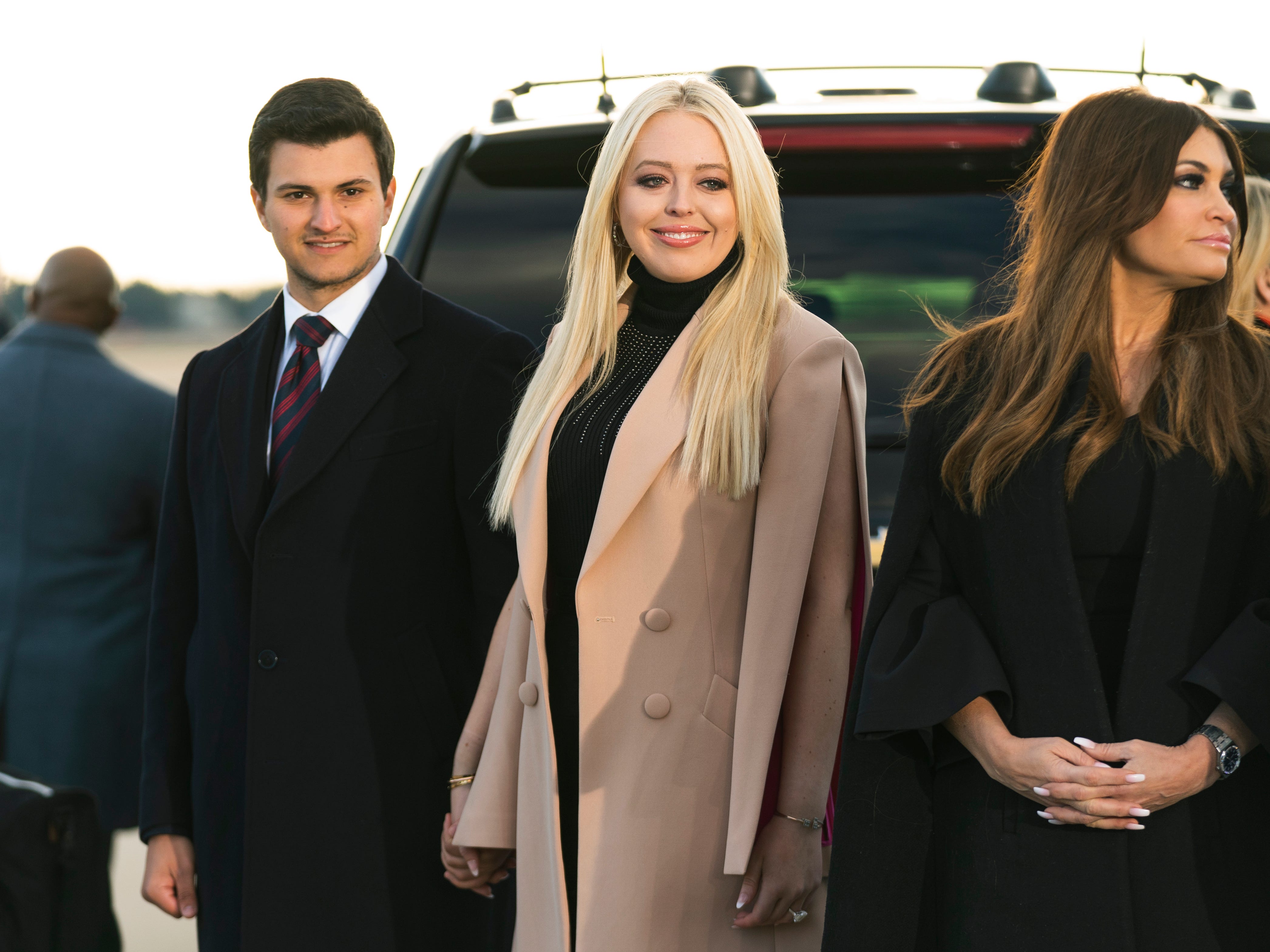 Tiffany Trump, center, and her fiance Michael Boulos wait for President Donald Trump at Andrews Air Force Base