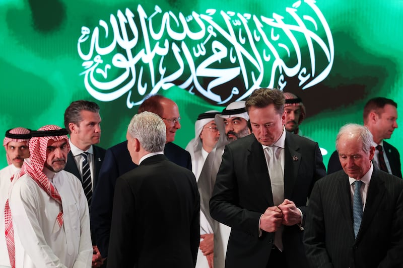 Elon Musk, Tesla CEO and Senior Advisor to the President of the United States views view an exhibit in the old district of Diriyah on the outskirts of the Saudi capital Riyadh on May 13, 2025, in Riyadh, Saudi Arabia. Defense Secretary Pete Hegseth was also on the tour.