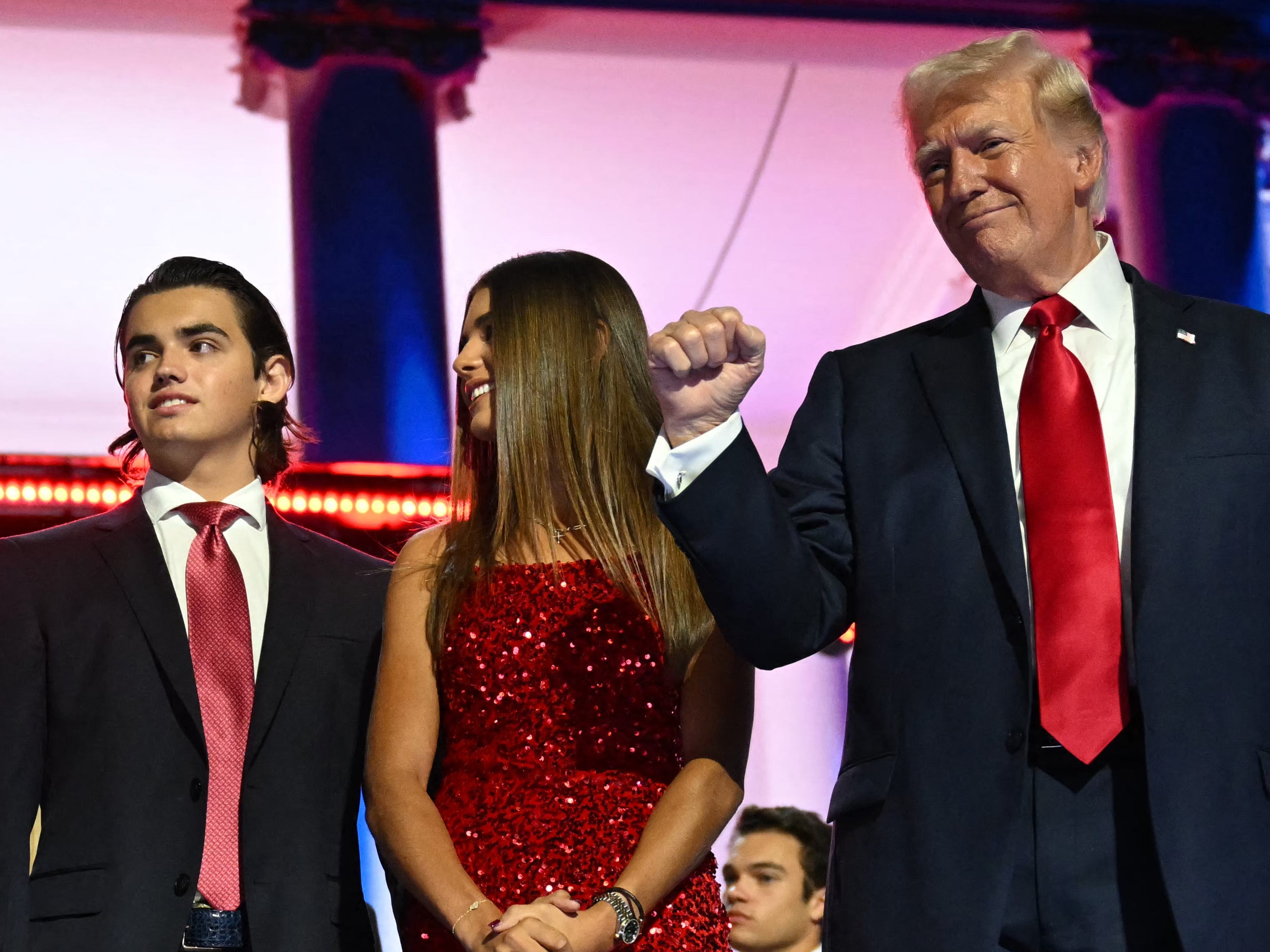 Donald John Trump III, Kai Trump, and Donald Trump onstage.