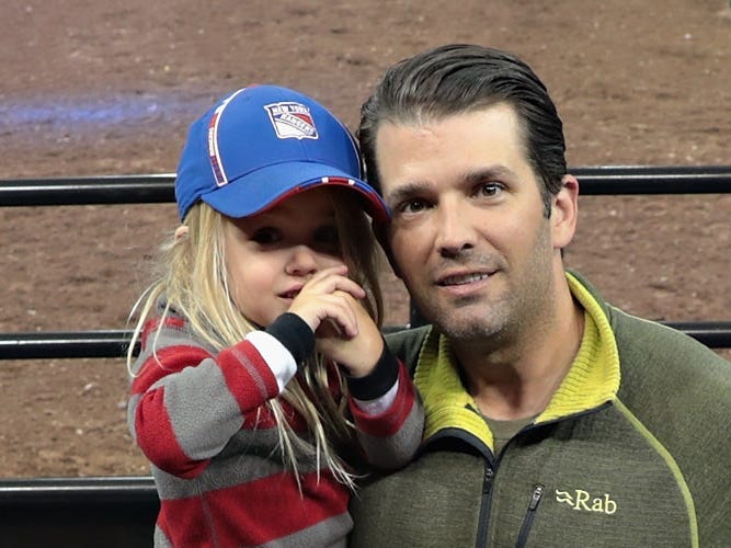 Donald Trump Jr. with his daughter Chloe Sophia Trump, who's wearing a cap.