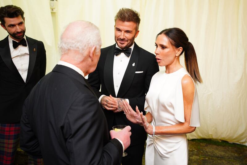 TETBURY, ENGLAND - FEBRUARY 07: King Charles III speaks to David Beckham and Victoria Beckham during a dinner in celebration of Slow Food at King Charles III's Gloucestershire estate, Highgrove Gardens on February 7, 2025 inTetbury, England. The King and Queen will join Hollywood star Stanley Tucci for a black tie dinner to celebrate Italian cuisine at Highgrove on Friday evening. The pair have invited the Italian-American Devil Wears Prada actor and well-known foodie and the Italian ambassador to the UK, Inigo Lambertini, to his Gloucestershire estate to enjoy a feast of sustainable Slow Food. (Photo by Ben Birchall - WPA Pool/Getty Images)