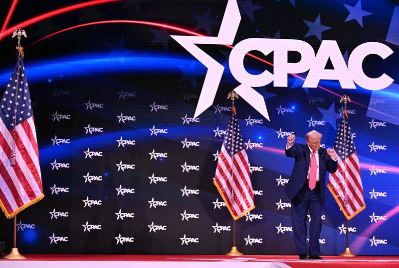 President Donald Trump dances on stage after speaking at the annual Conservative Political Action Conference (CPAC) in Oxon Hill, Maryland, on February 22, 2025.