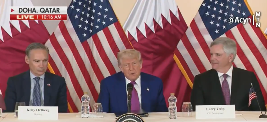 President Trump speaks to reporters in Doha, Qatar, on May 5, 2025, flanked by Boeing CEO Kelly Ortberg, left, and GE Aerospace CEO Larry Culp.