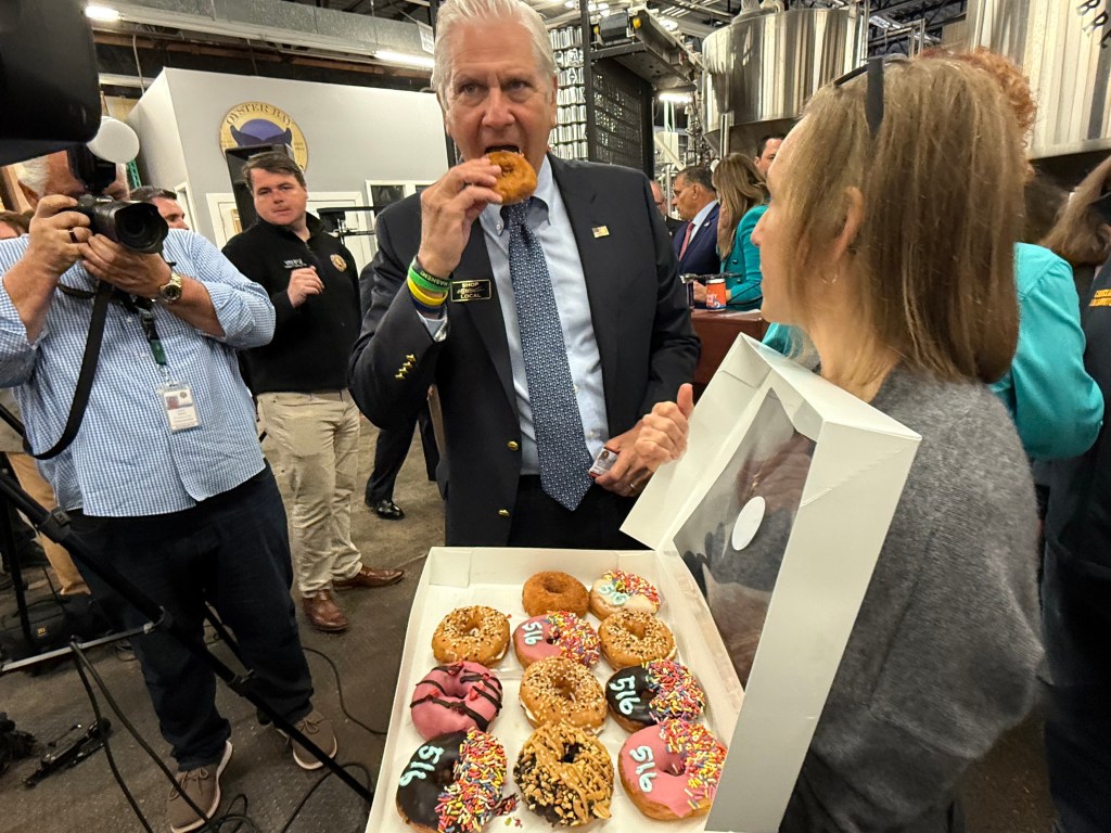 Blakeman sampling a 516-themed donut from Vice Donuts in Farmingdale.