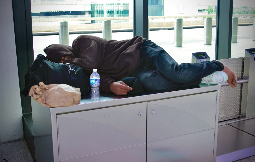 A passenger sleeping at Newark Liberty International Airport due to a delay on May 7, 2025.