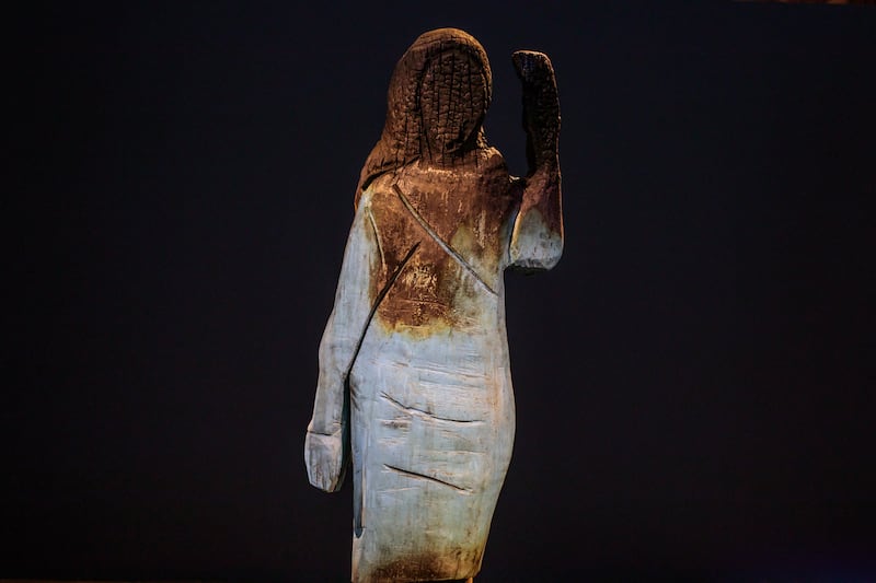 The fire-damaged wooden statue of Trump
