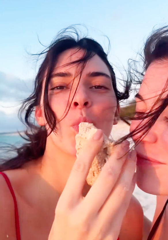 Kylie and Kendall Jenner laugh during a beach walk. 