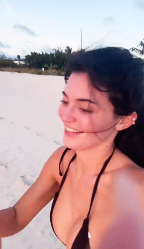 Kylie Jenner laughing on the beach. 