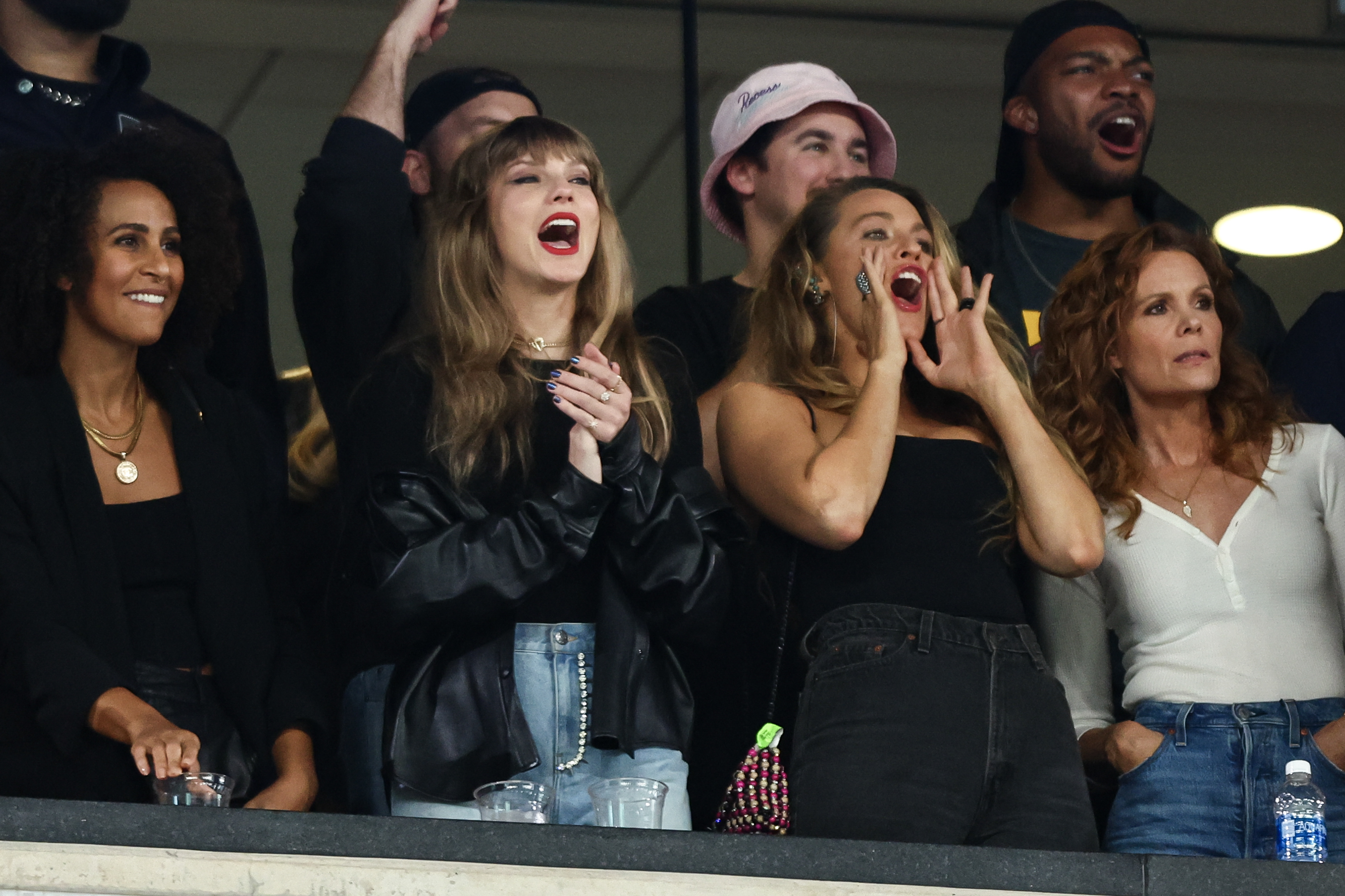 Blake Lively and Taylor Swift cheer at a football game. 