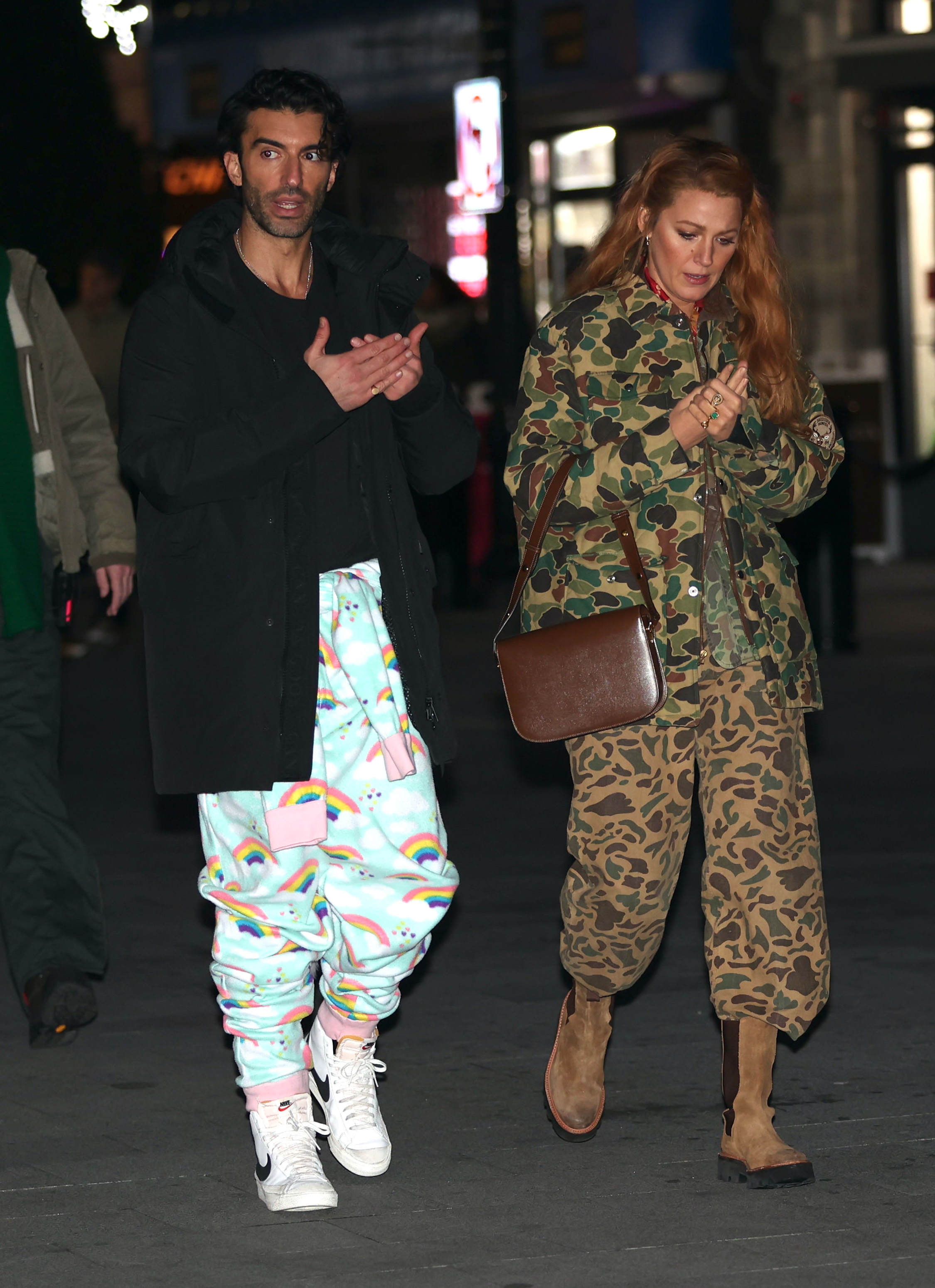 Blake Lively and Justin Baldoni walk together at night. 