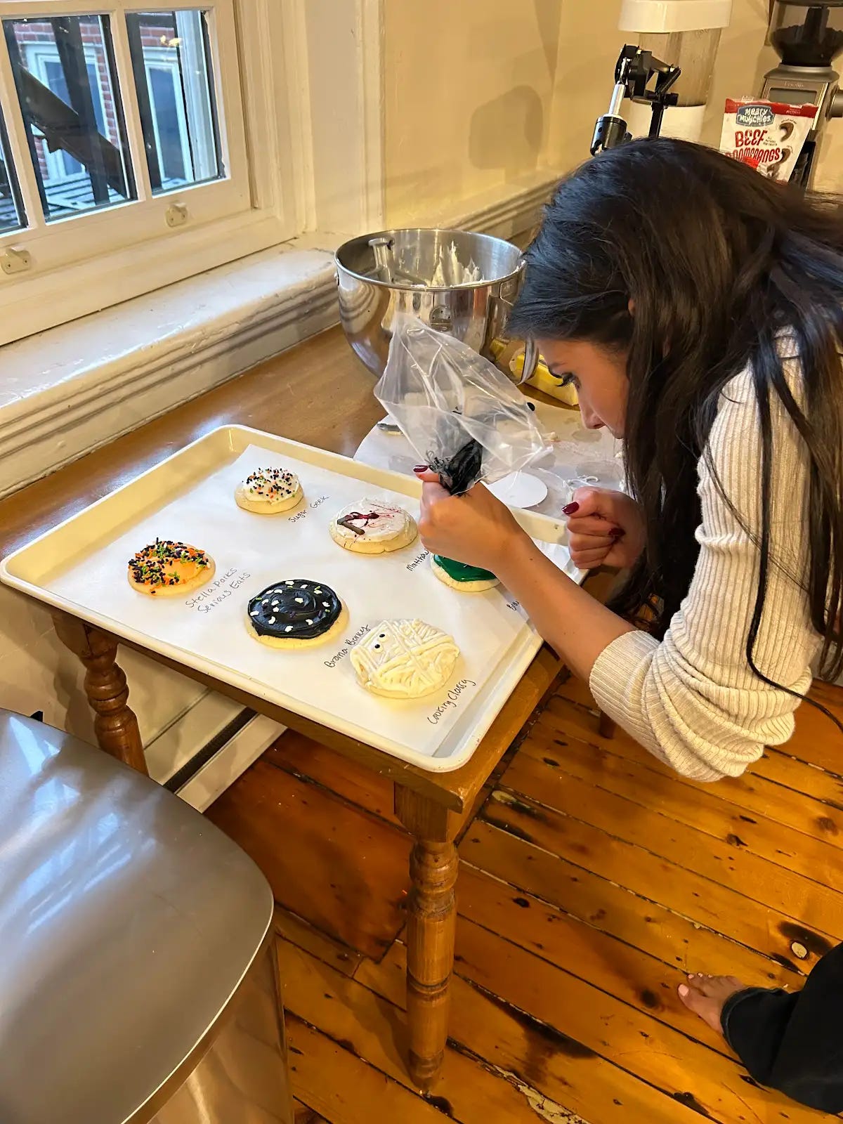 Alex George decorating Halloween cookies.