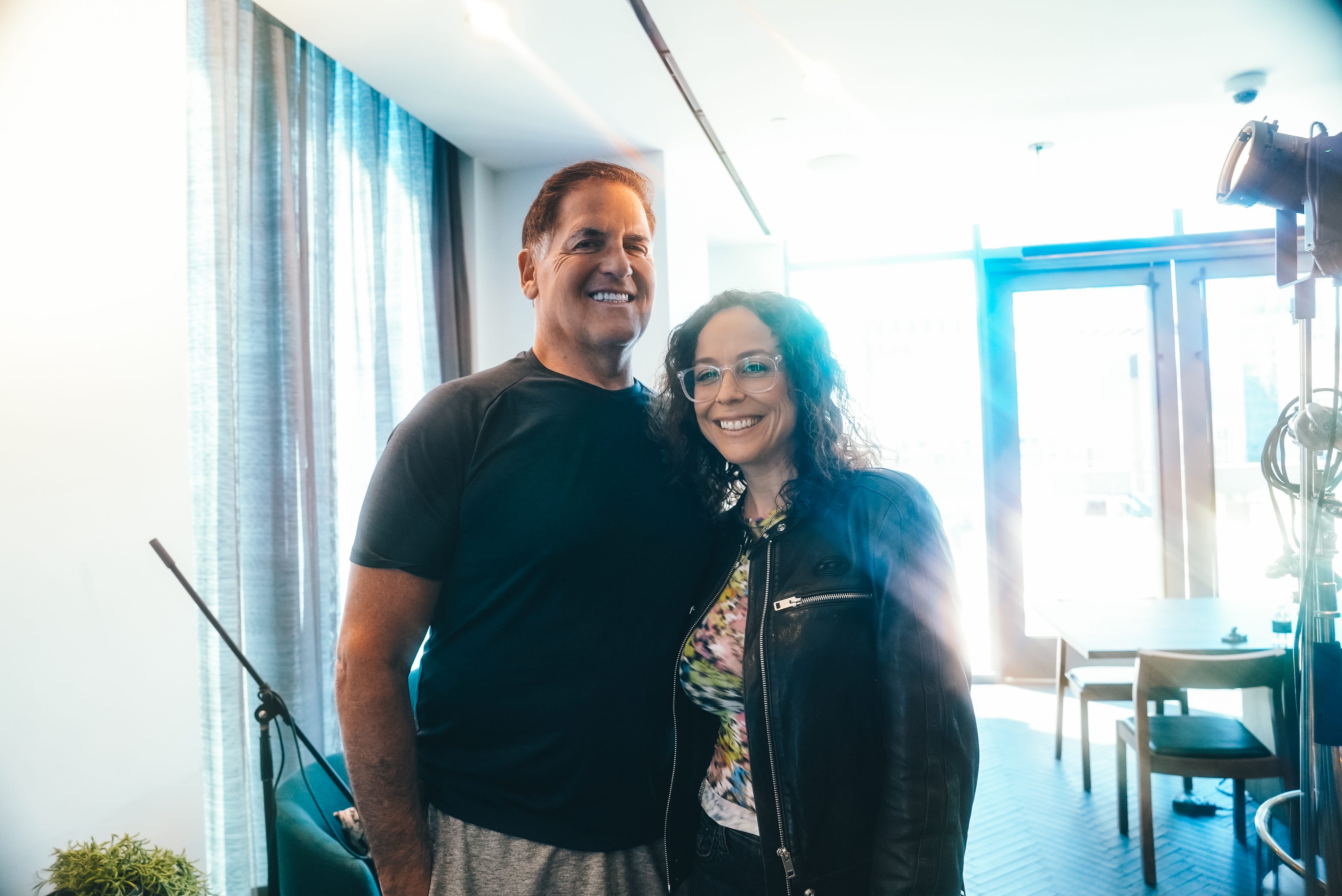 Mark Cuban posing with Shira Lazar in the podcast studio.