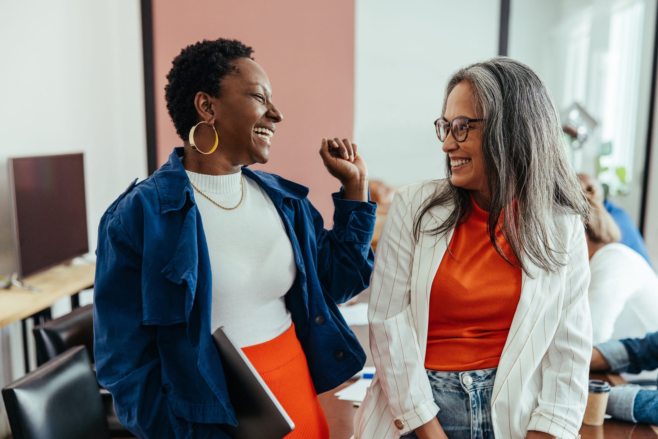 Two women in an office laughing together
