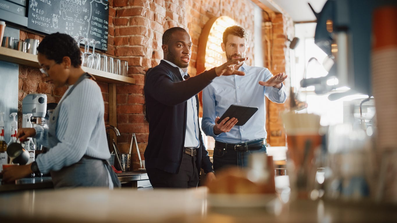 Two men having a discussion in a coffee shop