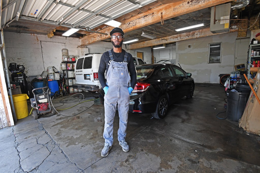 Small business owner Edwin Reed standing outside his shop, Sincere Detailing Pros, located in George Floyd Square, expressing his frustration over loss of business.