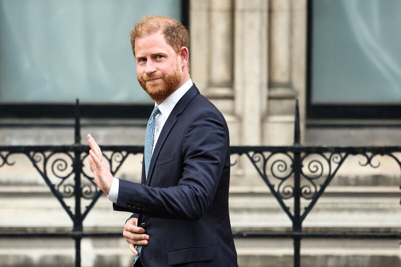 TOPSHOT - Britain's Prince Harry, Duke of Sussex waves as he leaves the High Court, in central London, on April 8, 2025 after an hearing about a decision of the British Government to downgrade his personal security during visits in Britain. Prince Harry's lawyer outlined in court threats made against him, as King Charles's youngest son appealed on April 8, 2025 against an