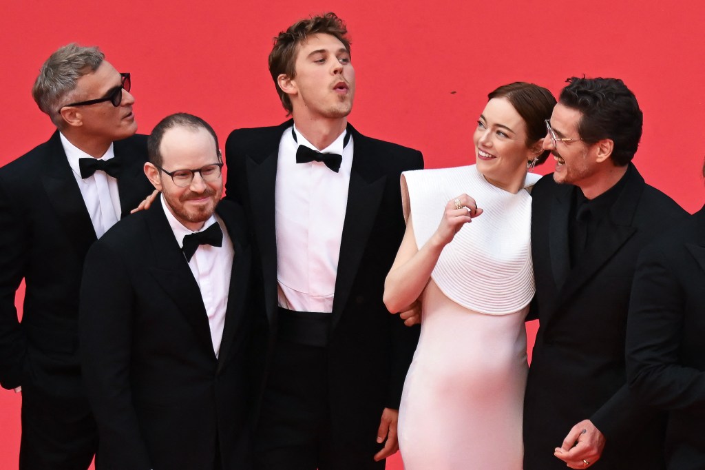 Emma Stone being attacked by a bee while posing with Austin Butler and Pedro Pascal at the Cannes Film Festival Friday. 