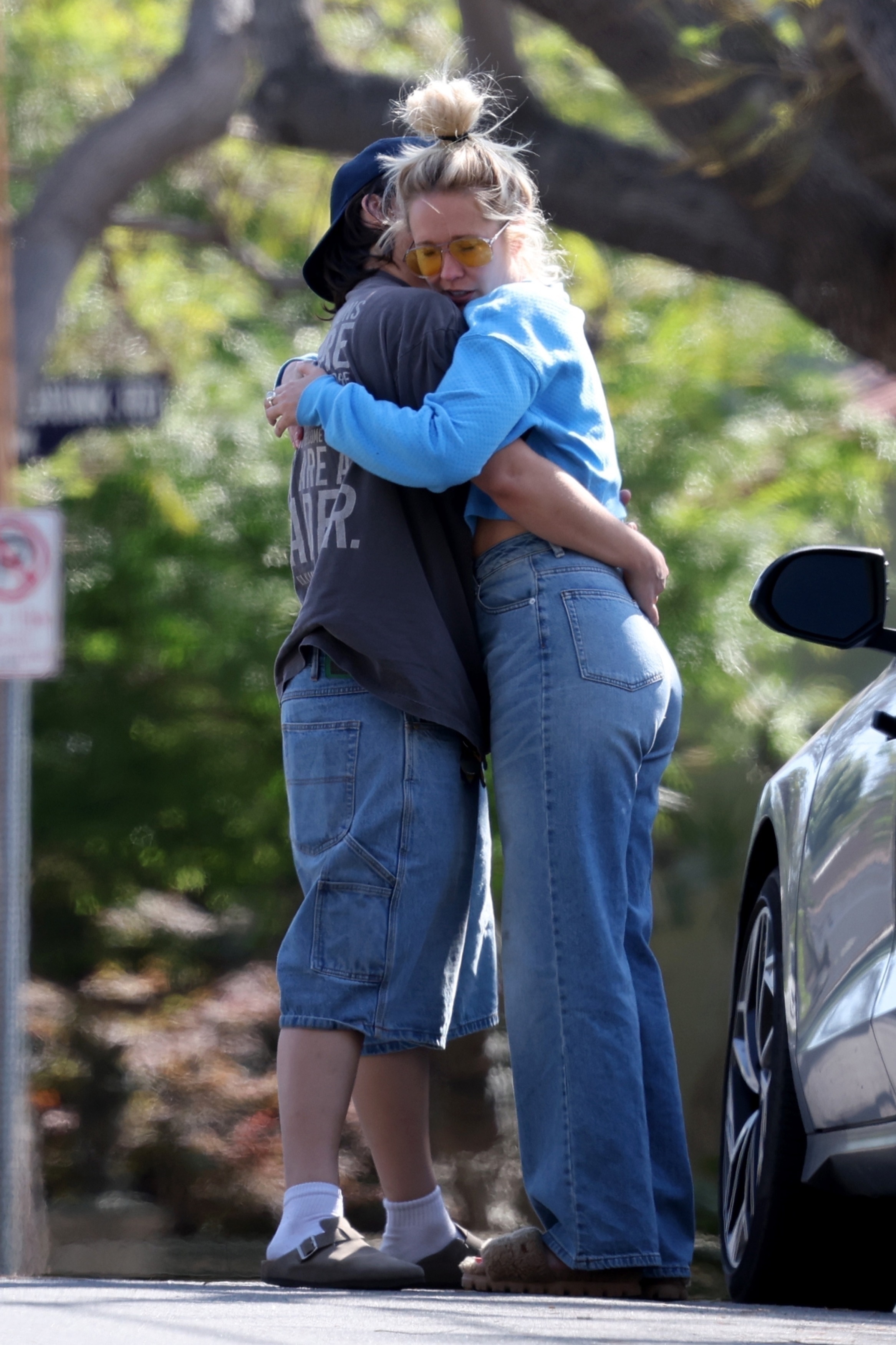 Anna Camp and Jade Whipkey hugging outdoors. 