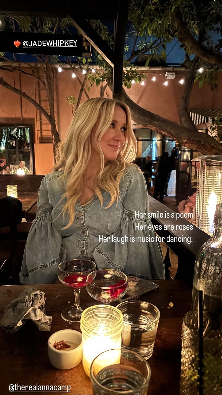 Anna Camp at a candlelit table. 